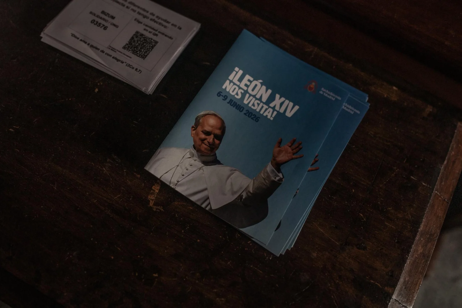 A pamphlet announcing a Papal visit to Madrid resting on