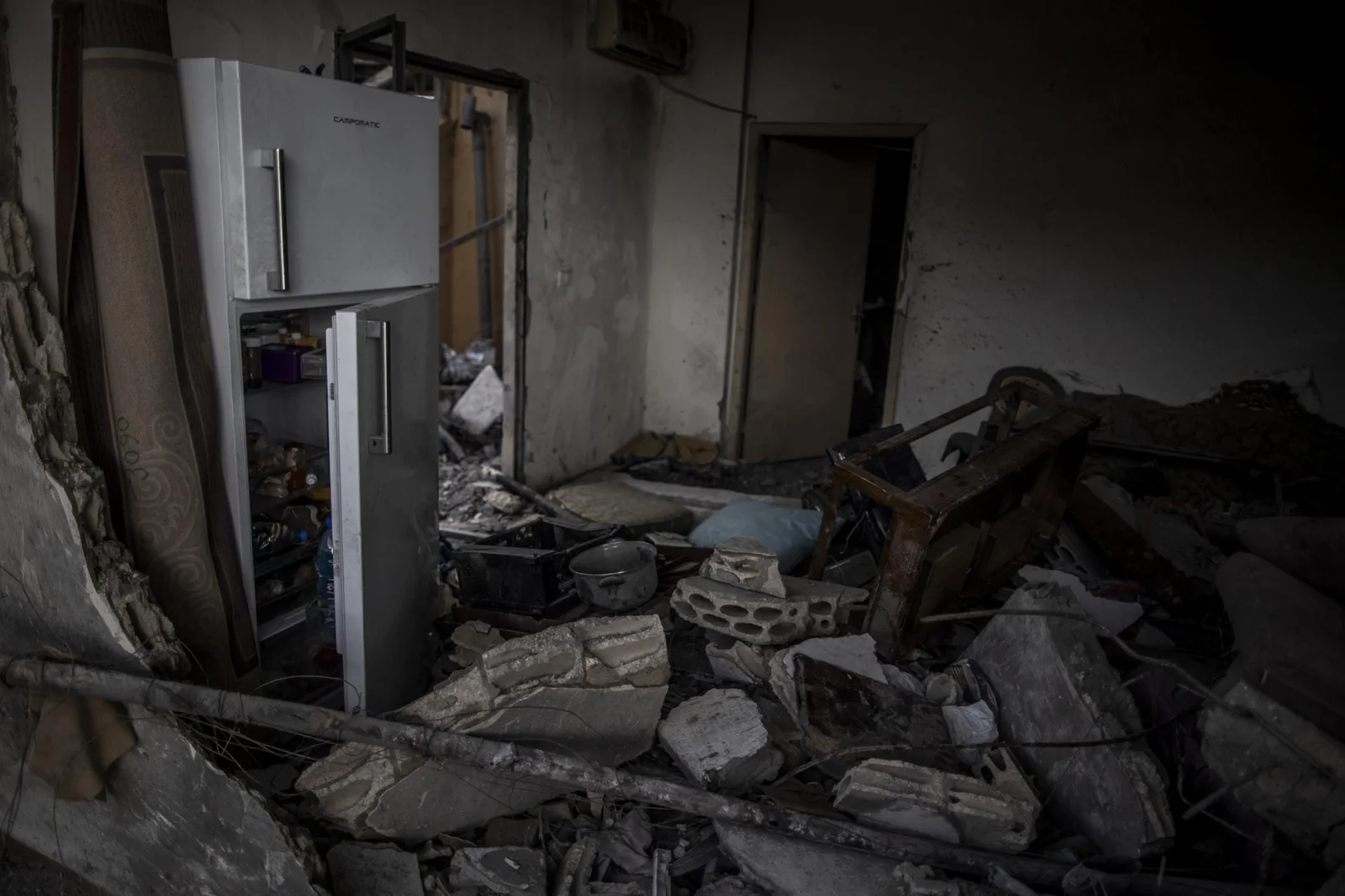 To the left of the room filled with debris from the