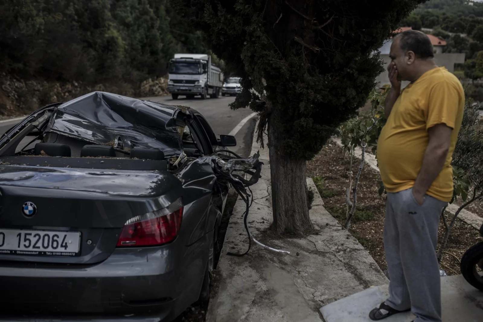 On the right, a resident of Maaysra laments at the sight