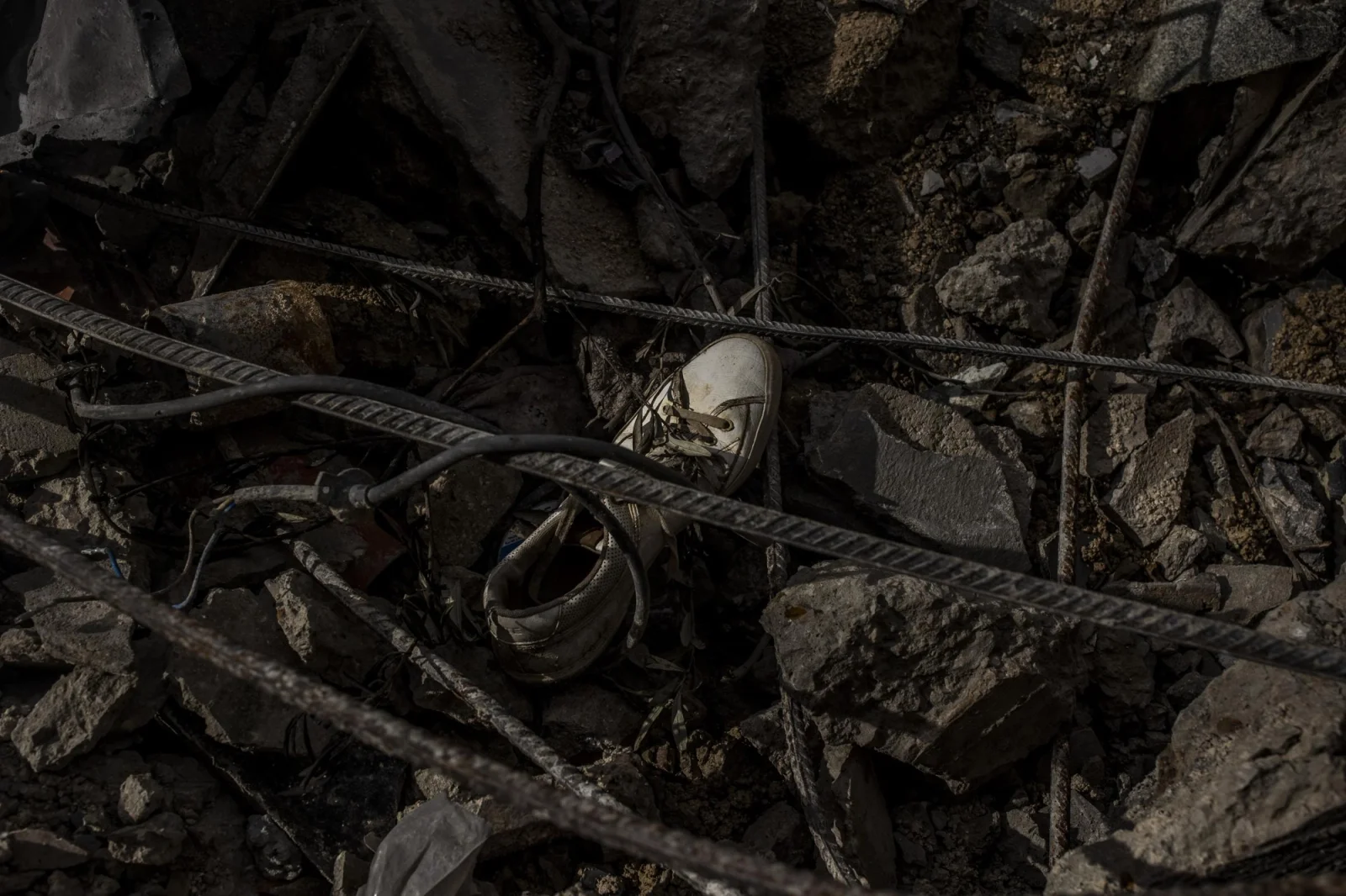 A shoe can be seen in the remains of the rubble of the