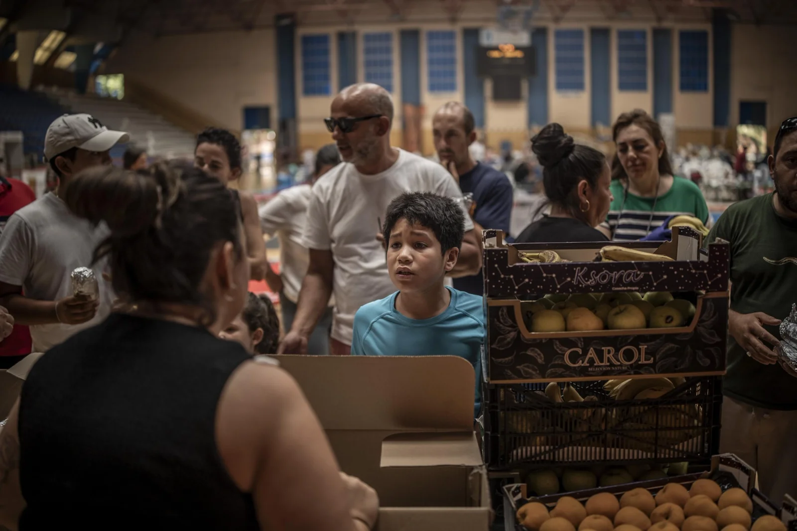 A child waits along the same line at the sports center in