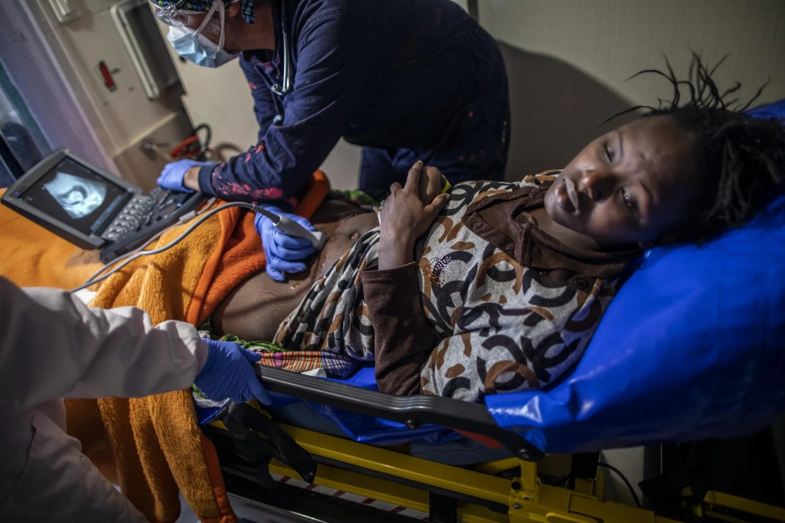 Sita Yakita, 16 years old, Guinea Conakry stays in the infirmary while Juanfe, the doctor on board the Spanish NGO Open Arms performs an ultrasound scan to see her unborn child,Sunday Feb.14, 2021