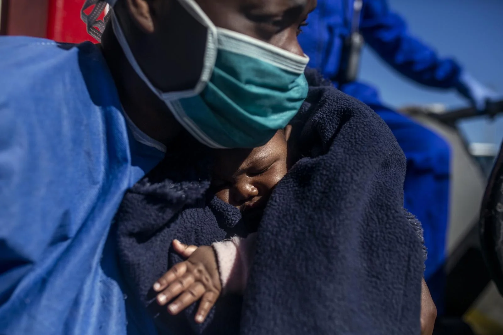 Sandrine,33 years old, Cameroon, holds her three-month-old son Moise moments before leaving the Spanish NGO Open Arms boat, in the Sicilian port of Empedocles, Italy, Tuesday, Feb. 16, 2021