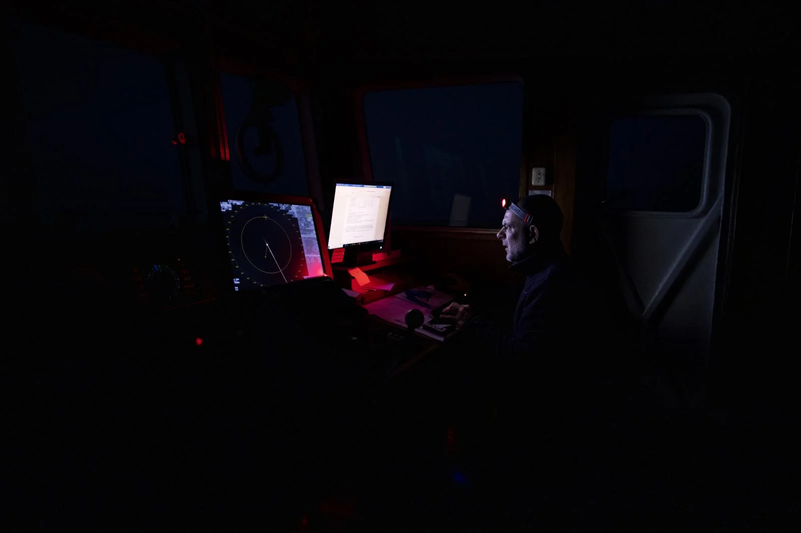 49-year-old 'Erri' from Bilbao, Chief Mate of the Spanish NGO Open Arms during a watch a few hours before dawn analyses the latest data on the ship's position and direction, Saturday Feb.6,2021